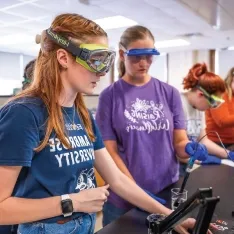 Students conducting experiments in a chemistry lab.